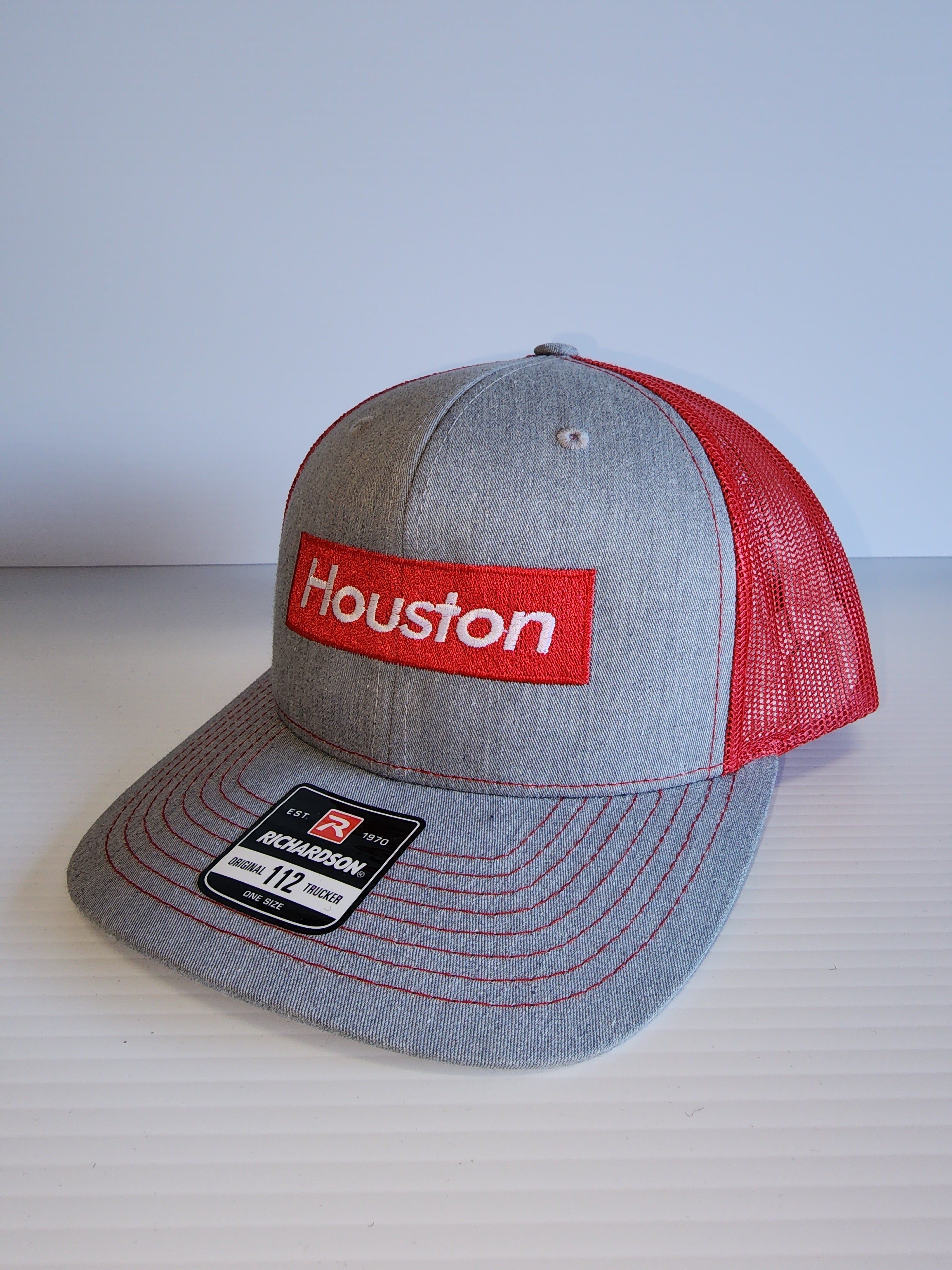 Houston Supreme on a Grey/Red Trucker Cap